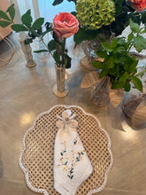 Load image into Gallery viewer, Orchid napkin ring styled on an embroidered napkin with woven tabletop accessories